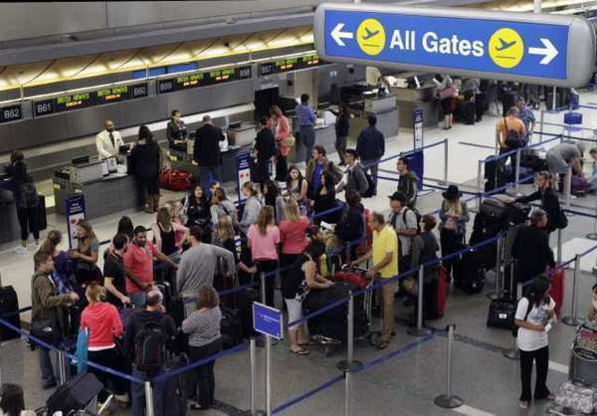 Travelers inside the LAX Tom Bradley International Terminal in Los Angeles. Priceline, Orbitz and Expedia stock all sank Wednesday.