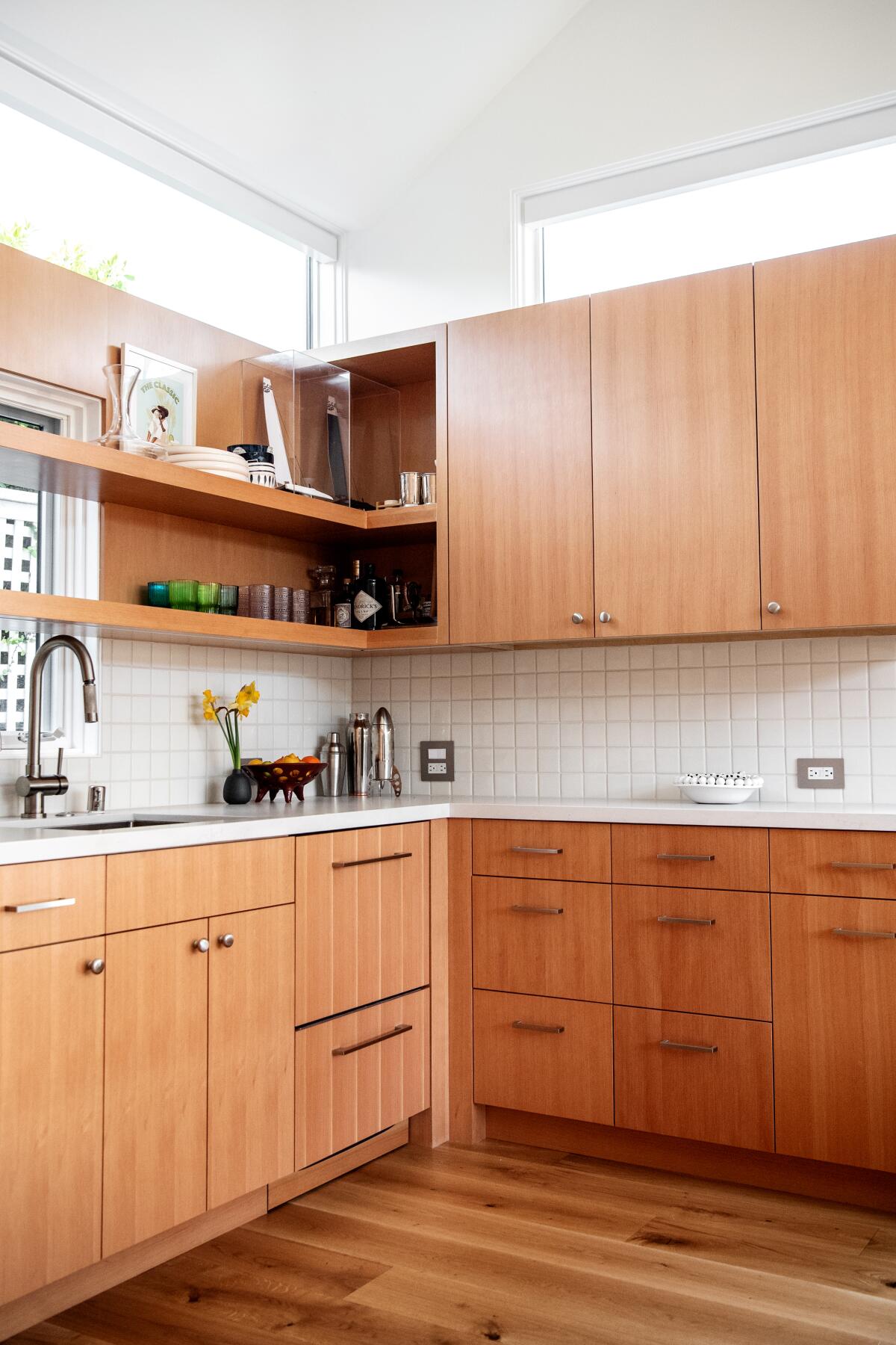 Open shelving mixes with wood cabinetry on the top level of storage for this kitchen.