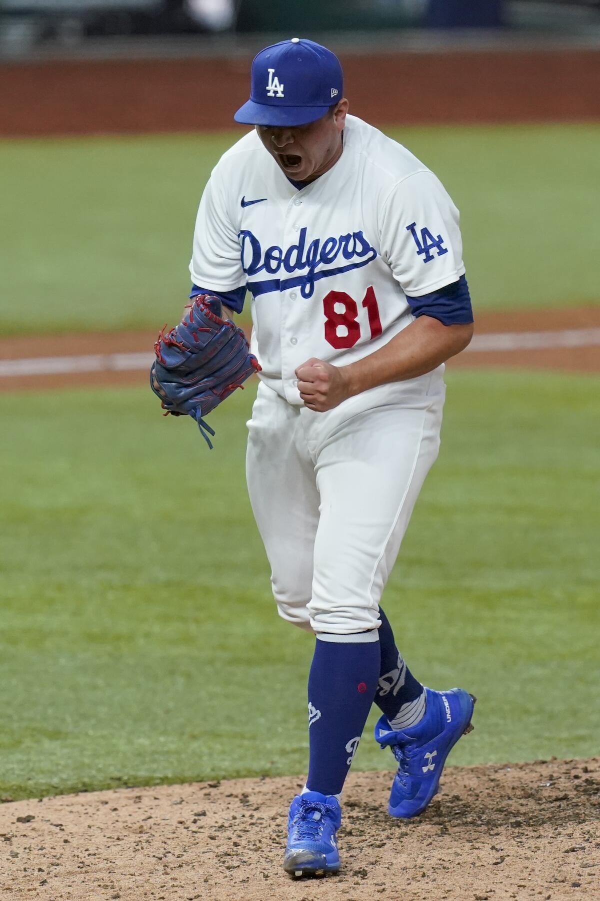 Dodgers pitcher Victor Gonzalez celebrates after striking out Atlanta's Charlie Culberson.