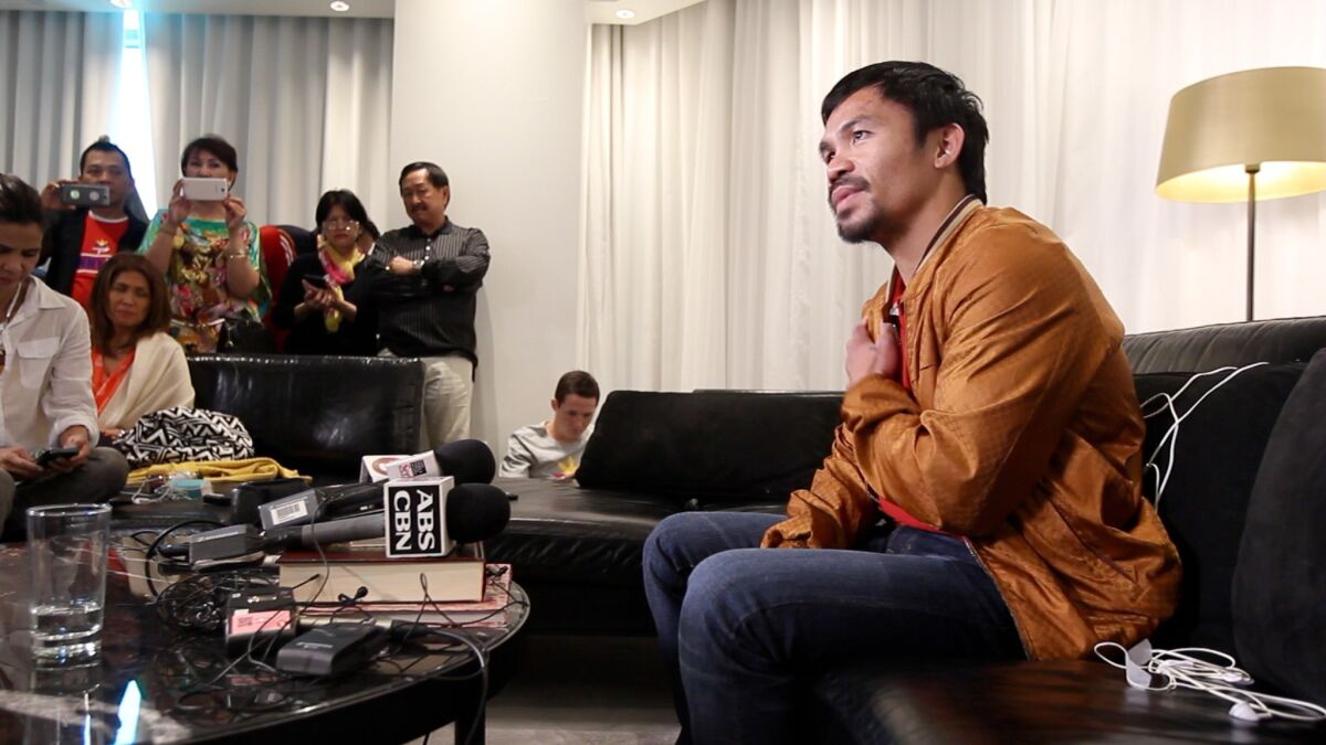 Manny Pacquiao speaks to the media about his hurt shoulder on Sunday in his Las Vegas hotel room.