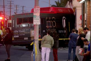 LONG BEACH, CALIF. - Long Beach police and fire department personnel investigate the scene of a bus crash on South Street in Long Beach, which resulted in injuries to 14 people on Thursday, Nov. 9, 2023. (Luis Sinco / Los Angeles Times)