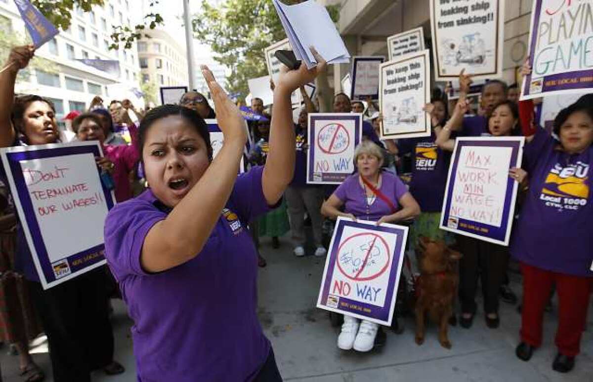 (Los Angeles, CA - July 24, 2008) SEIU Local 1000 organizer Jennifer Ortiz leads a group of California state workers in a chant protesting a proposal by Governor Arnold Schwarzenegger to cut their pay as state legislators struggle to pass a budget.