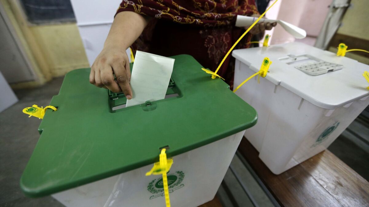 A woman casts her ballot during parliamentary elections in Pakistan on July 25 .