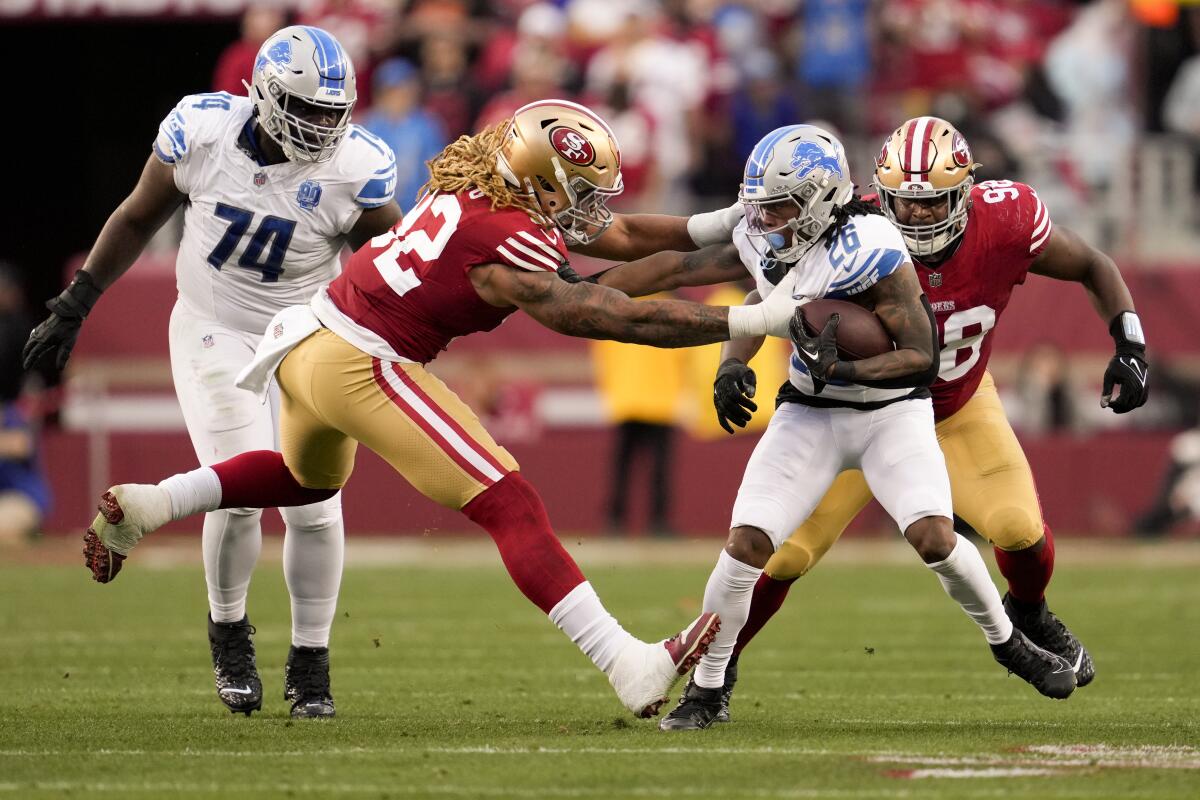 The Lions' Jahmyr Gibbs is tackled by the 49ers' Chase Young during the NFC championship game. 