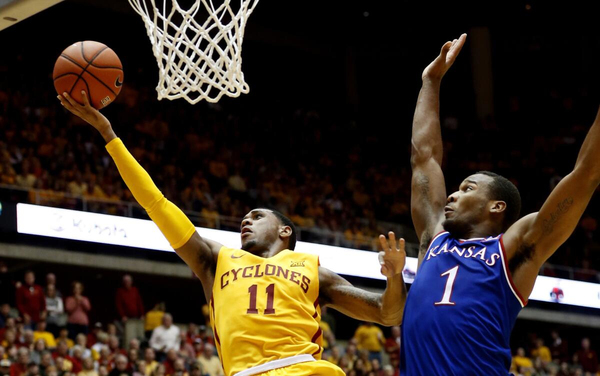 Iowa State guard Monte Morris goes up for a layup as Kansas defender Wayne Selden Jr. tries to block his shot during the first half.