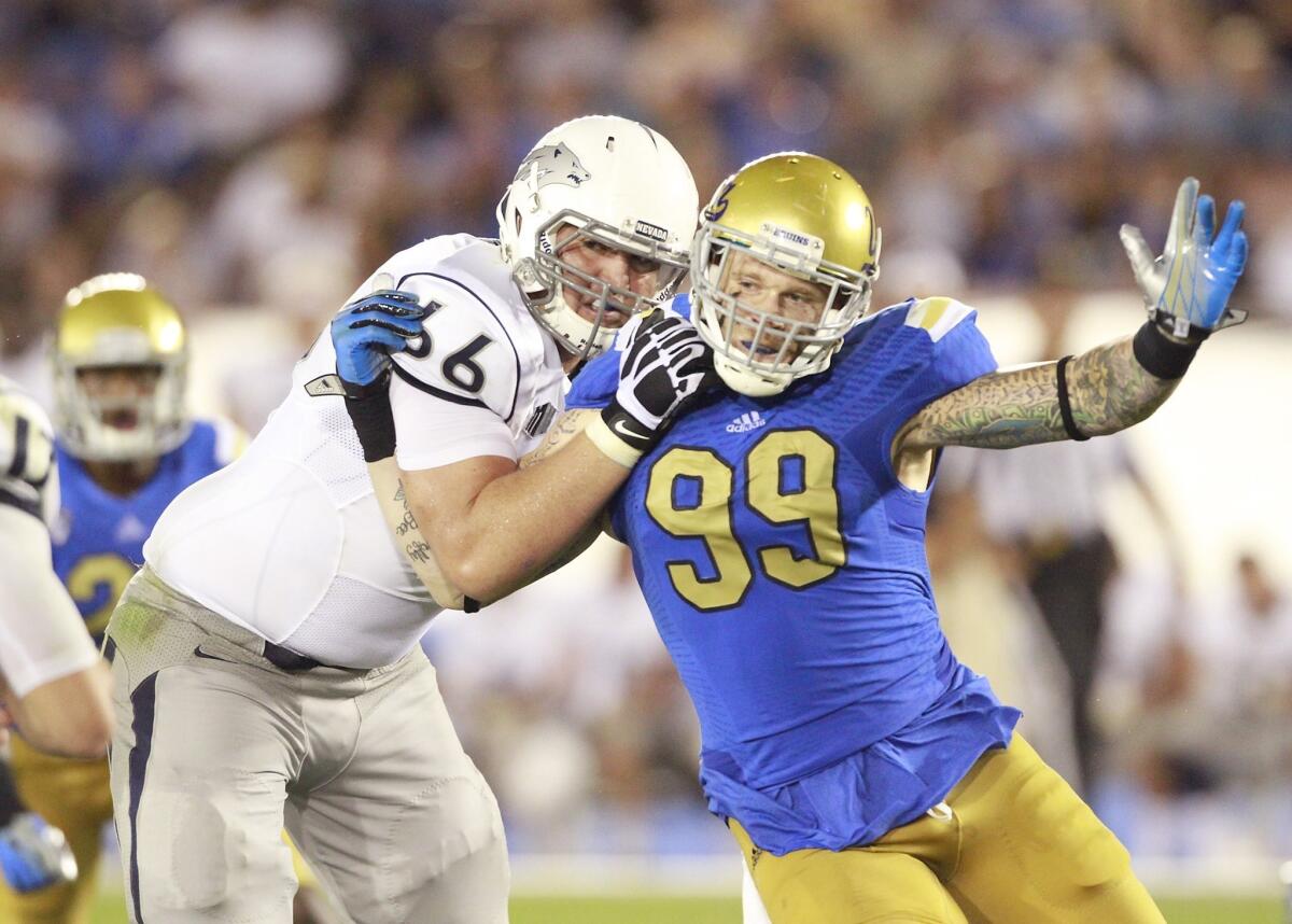 UCLA defensive end Cassius Marsh, right, tries to get past Nevada's Kyle Roberts during the Bruins' season-opening win in August.