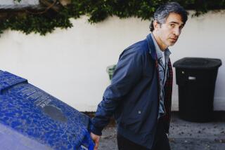Chris Messina is photographed pulling a blue trash bin in Santa Monica