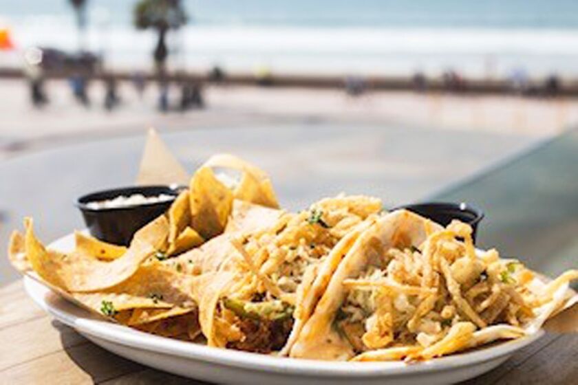 Enjoy ocean views while eating fish tacos at Sandbar Sports Bar & Grill.