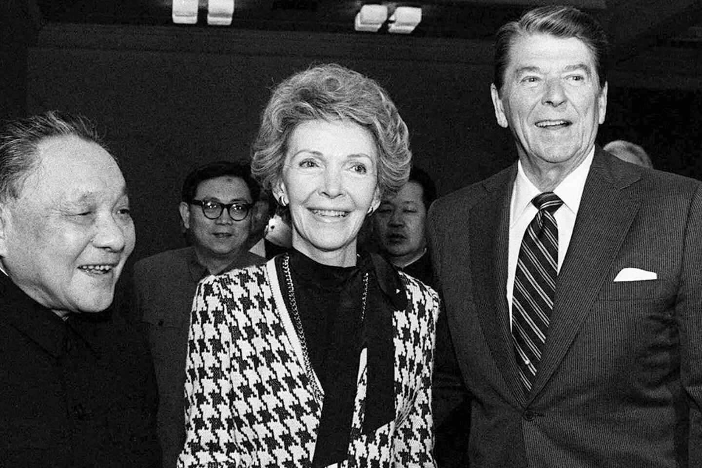 Nancy Reagan holds Chinese leader Deng Xiaoping's hand during a 1984 visit to Beijing. The first lady took an active role in advising President Reagan on policy matters.