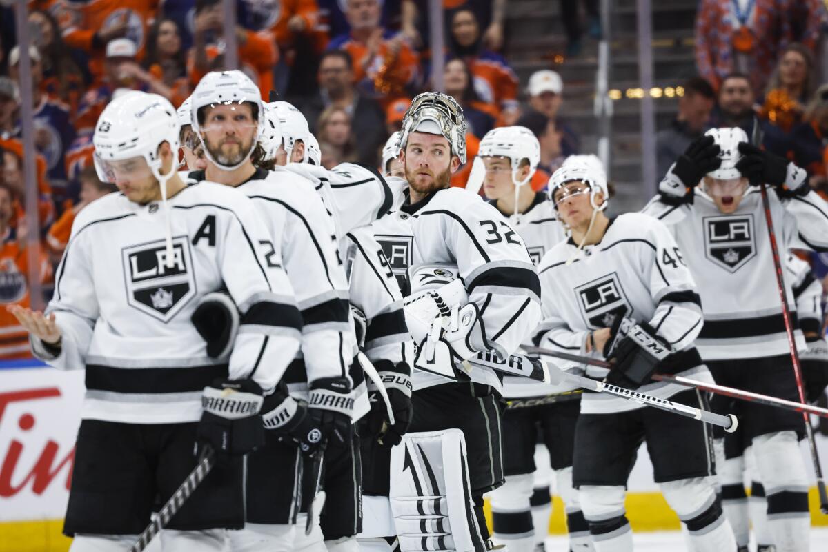 Kings goalie Jonathan Quick and teammates watch as the Edmonton Oilers celebrate.