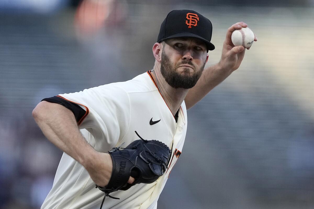 FILE - San Francisco Giants starting pitcher Alex Wood (57) delivers against the Los Angeles Angels during the first inning of a baseball game Tuesday, June 1, 2021, in San Francisco. Left-hander Alex Wood is staying with the San Francisco Giants, reaching agreement Wednesday, Dec. 1, 2021 on a $25 million, two-year contract. He gives manager Gabe Kapler two starters named Alex in the rotation after Tuesday's addition of right-hander Alex Cobb on a $20 million, two-year contract with a club option for 2024. (AP Photo/Tony Avelar, File)