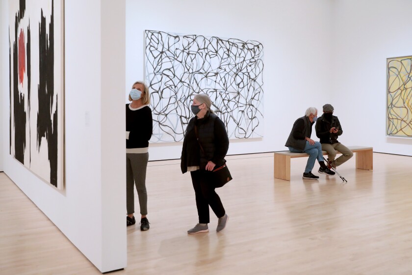 SAN FRANCISCO, CA - MARCH 15: Guests observe the Approaching American Abstraction exhibit in the Doris and Donald Fisher Collection Gallery at the San Francisco Museum of Modern Art (SFMOMA) on Monday, March 15, 2021 in San Francisco, CA. SFMOMA reopened to the public on March 7, 2021. On March 2, 2021, the San Francisco Department of Public Health updated a COVID-19 health order to allow many businesses to reopen at the Red Tier. (Gary Coronado / Los Angeles Times)