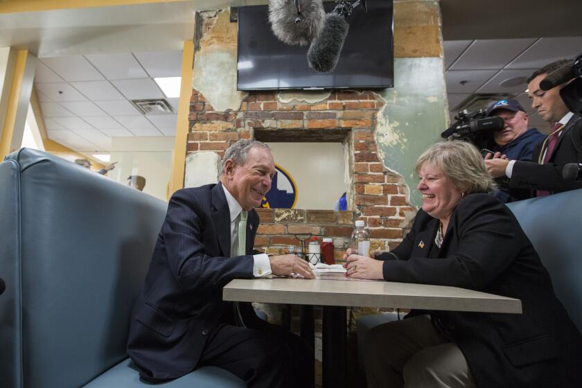 Democratic Presidential candidate Michael Bloomberg speaks with Virginia delegate-elect Nancy Guy during his campaign stop in Norfolk, Va., Monday, Nov. 25, 2019. (AP Photo/Bill Tiernan)
