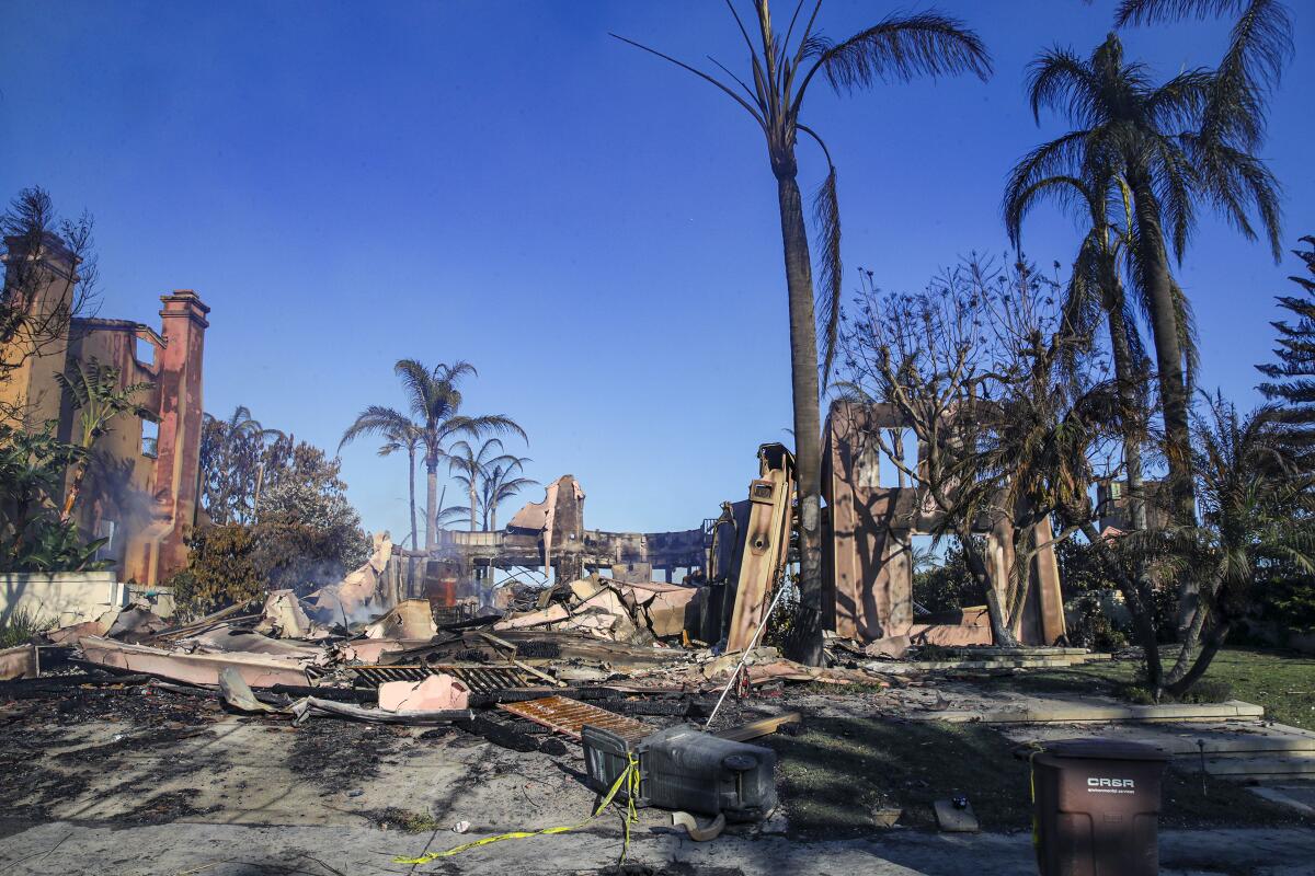 Homes burned in the Coastal fire smolder in Laguna Niguel on May 12, 2022. 
