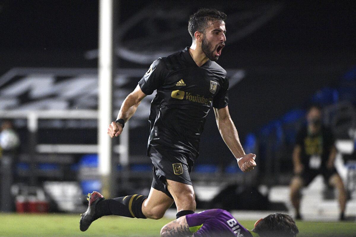 LAFC's Diego Rossi reacts after scoring past Galaxy goalie David Bingham, at bottom, in the second half July 18, 2020.