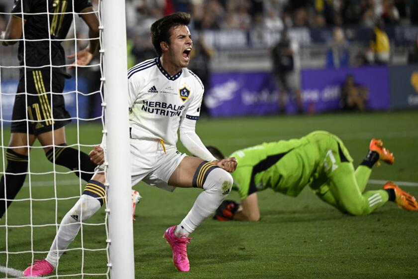 PASADENA, CA - JULY 04: LA Galaxy midfielder Riqui Puig (6) celebrates after scoring against Los Angeles FC goalkeeper John McCarthy, right, during the second half of a MLS soccer match at Rose Bowl Stadium on Tuesday, July 4, 2023 in Pasadena, CA. (Alex Gallardo/For the Times)