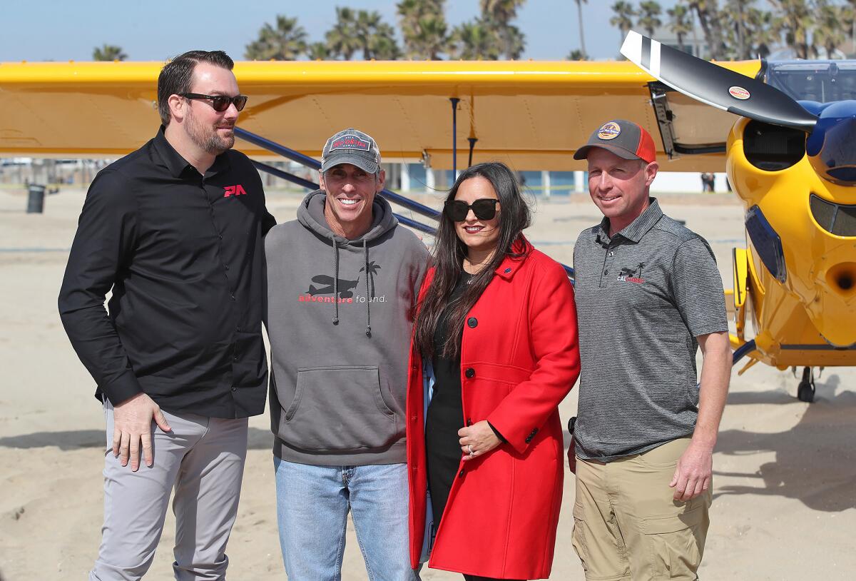 Kevin Elliott, pilot Bruce Graham, Huntington Beach Mayor Gracey Van Der Mark and pilot Casey Pozdolski.