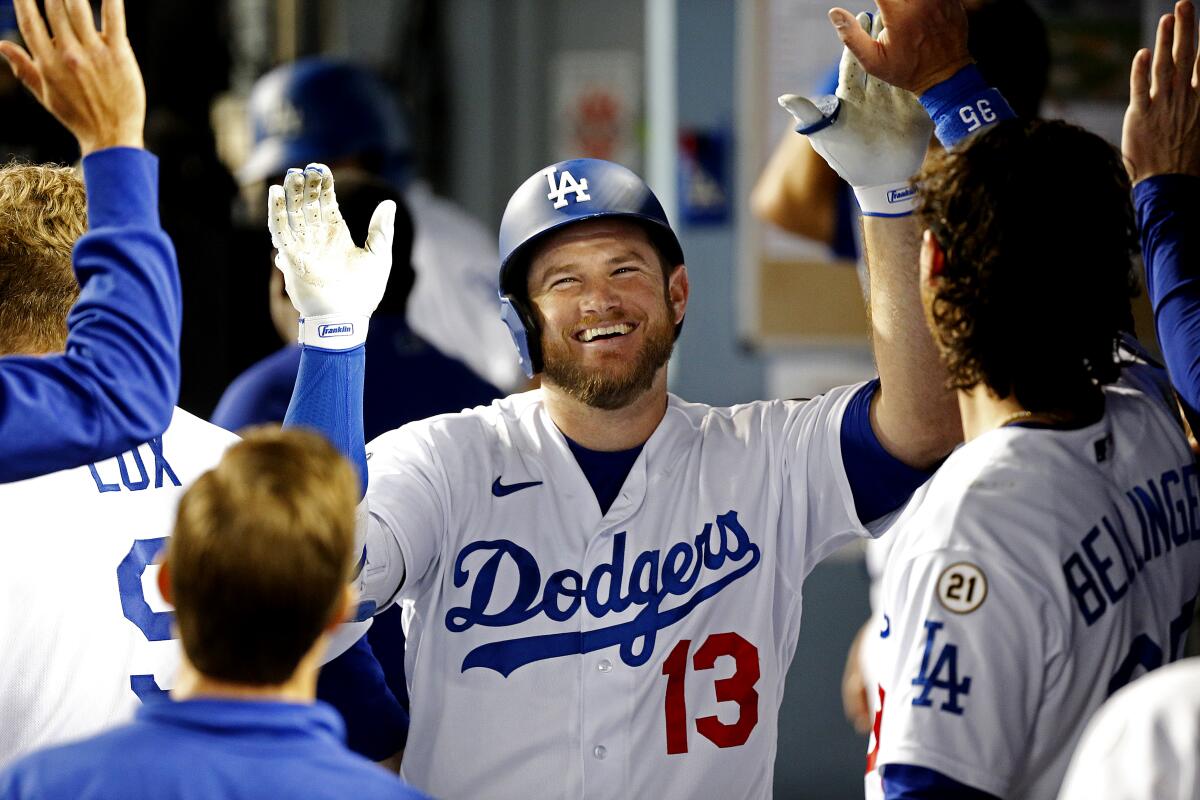 Dodgers first baseman Max Muncy celebrates with his teammates after hitting a solo home run.