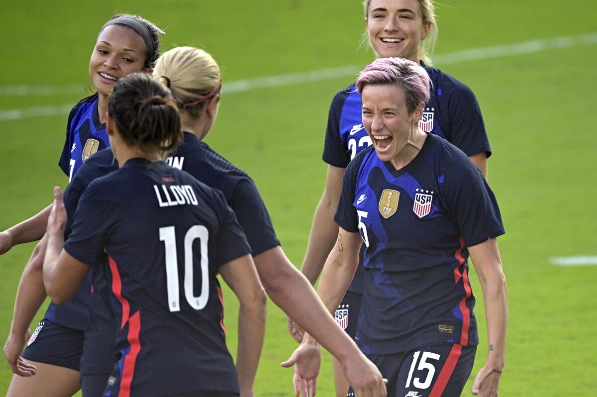 Megan Rapinoe, front right, celebrates with teammates after scoring a goal.