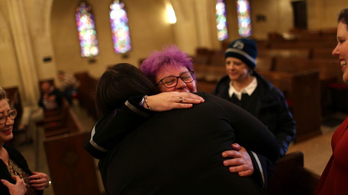 The Rev. Denyse Barnes, an openly lesbian United Methodist minister, hugs Angela Knapp, left, before a sermon at Hollywood United Methodist Church.