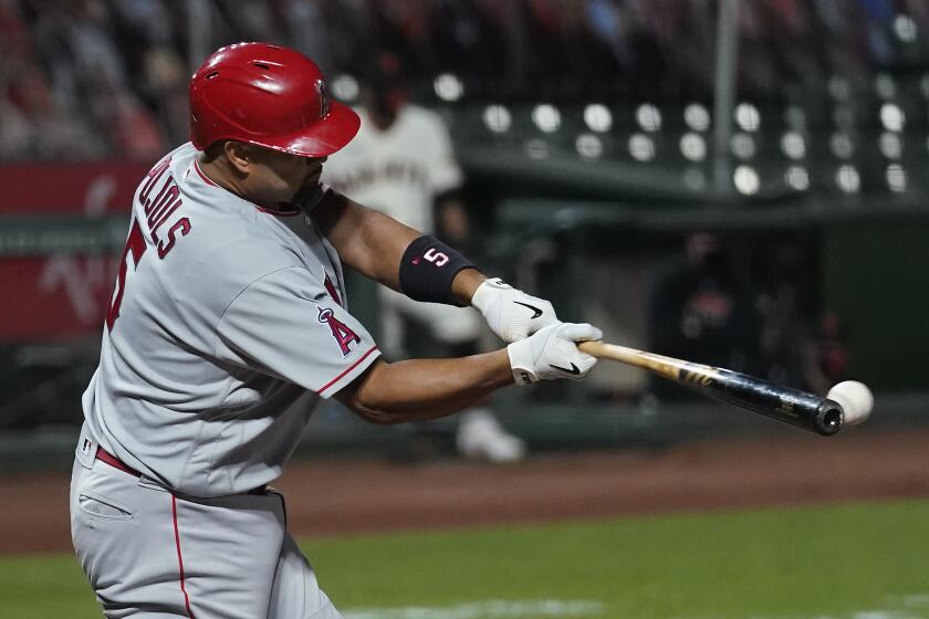 Los Angeles Angels' Albert Pujols hits a run-scoring single against the San Francisco Giants during the sixth inning of a baseball game in San Francisco, Wednesday, Aug. 19, 2020. (AP Photo/Jeff Chiu)