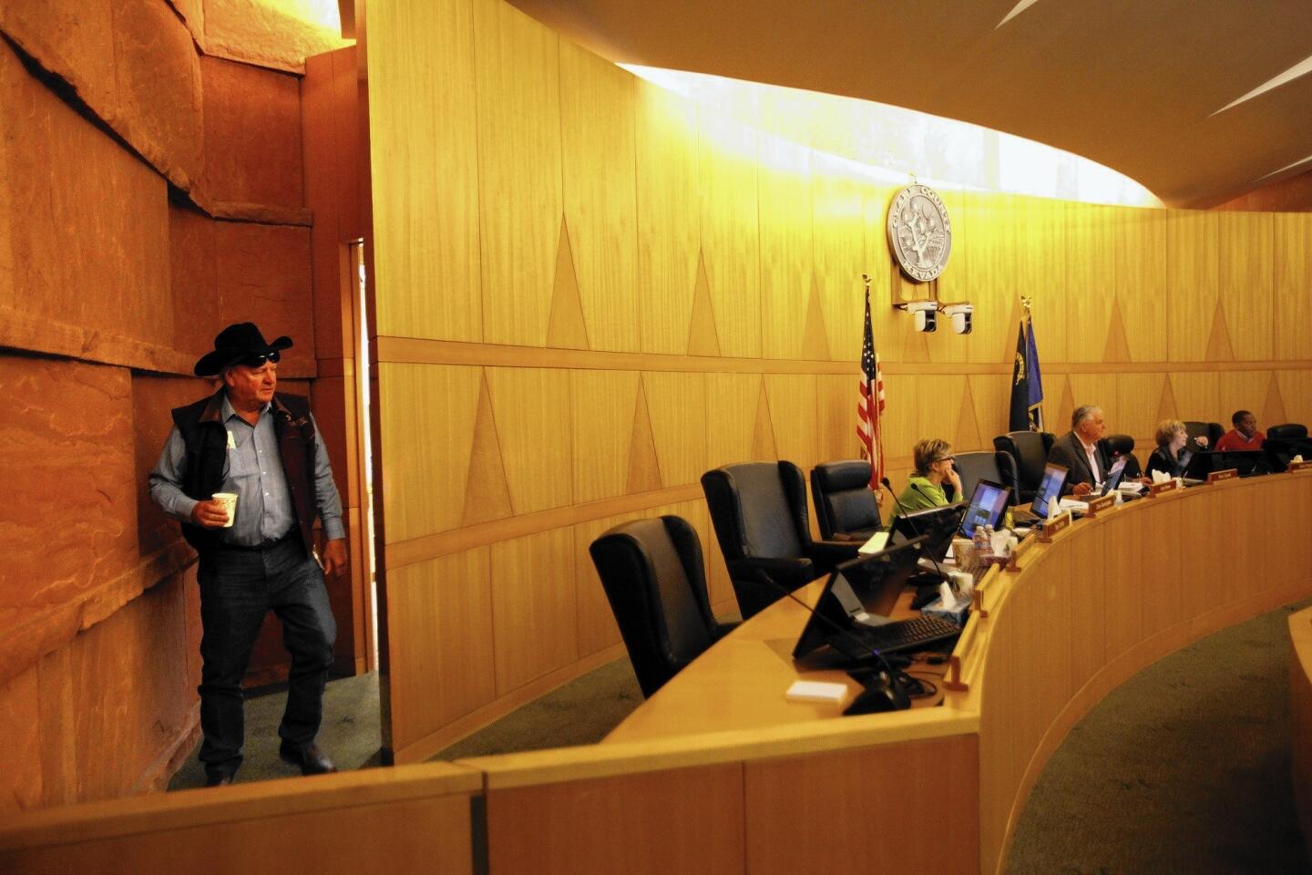 Clark County Commissioner Tom Collins arrives for a zoming meeting in his signature worn jeans and black Stetson.