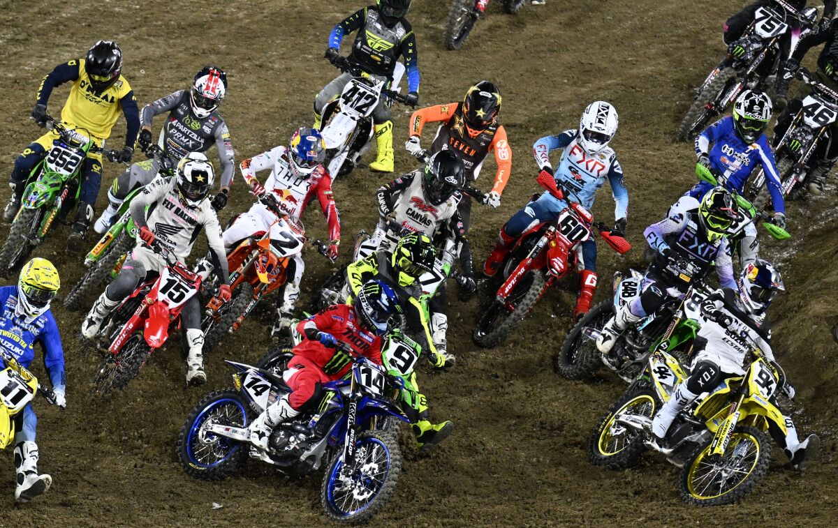 Riders race in the fourth heat of the Supercross Championship event. 