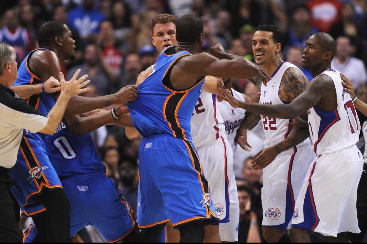 Oklahoma City's Serge Ibaka, left, is held back during a skirmish with Clippers teammates Blake Griffin, far left, Matt Barnes, second from right, and Jamal Crawford during Wednesday's game.