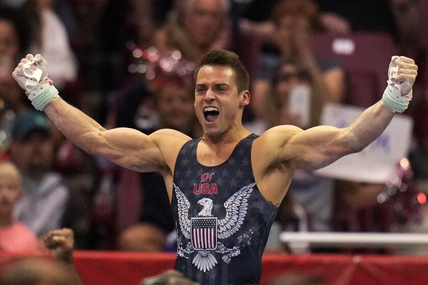 Sam Mikulak celebrates his performance on the still rings during the Olympic trials June 26, 2021, in St. Louis. 