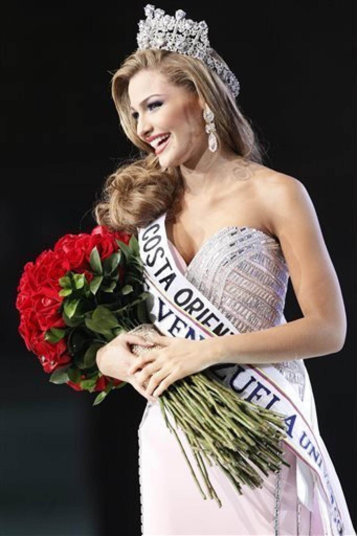 Miss Costa Oriente, Migbelis Castellanos smiles after being crowned as Miss Venezuela 2013 during the beauty pageant in Caracas, Venezuela, Thursday, Oct. 10, 2013. (AP Photo/Ariana Cubillos)