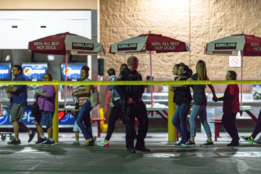 Shooting that occurred tonight inside a Costco in Corona, C.A. Multiple victims were transported by ambulance and at least one person was left dead inside the store. Customers are lead out of store. On June 14, 2019. (Patrick Smith/For the Times)