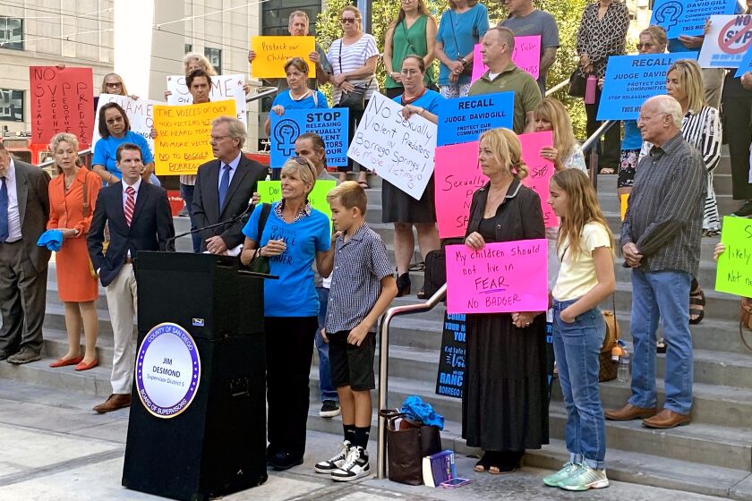 Laura Anderson stands next to her 12-year-old son, speaking against allowing a sexually violent predator to move into her neighborhood in Borrego Springs in front of the San Diego Central Courthouse August 5.