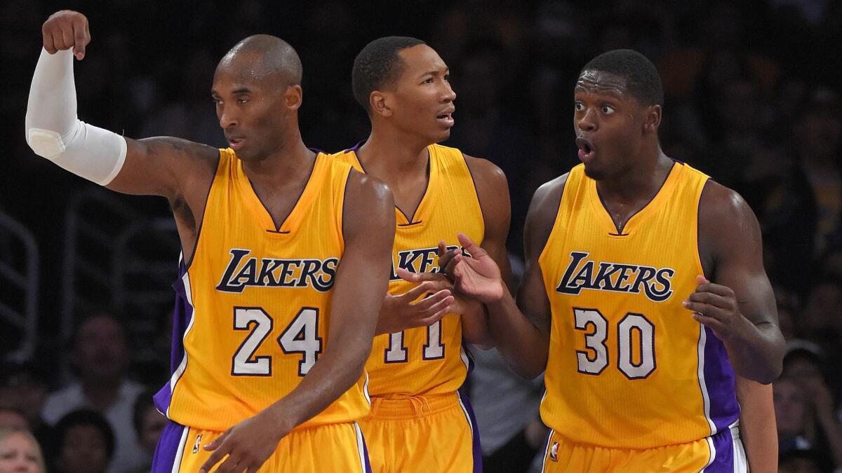 Kobe Bryant, Wesley Johnson and Julius Randle react to a referee's decision to nullify a basket during the Lakers' 98-91 win over the Utah Jazz on Oct. 19.