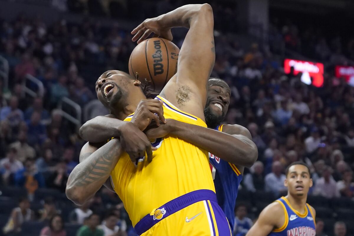 Los Angeles Lakers center Dwight Howard, left, is fouled by Golden State Warriors forward Draymond Green during the first half of an NBA basketball game in San Francisco, Thursday, April 7, 2022. (AP Photo/Jeff Chiu)