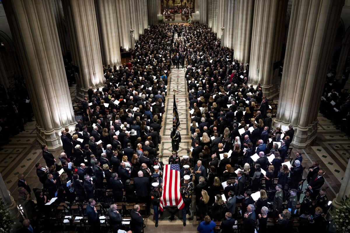 The Honor Guard carries the casket of former U.S. President George H. W. Bush following his funeral on Dec. 5 in Washington, DC.