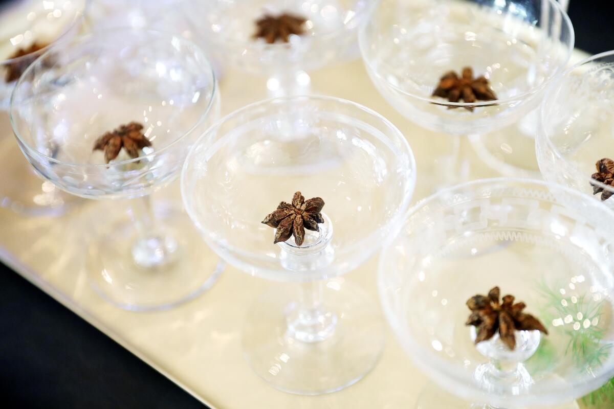 Add, flavor, texture and color by dropping star anise pods into glasses.