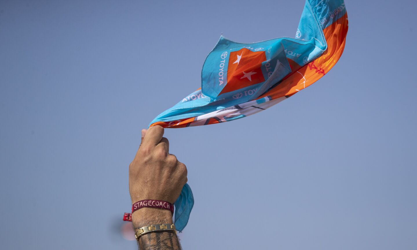 A fan waves a Stagecoach bandana while listening to Ashley McBryde perform Sunday.