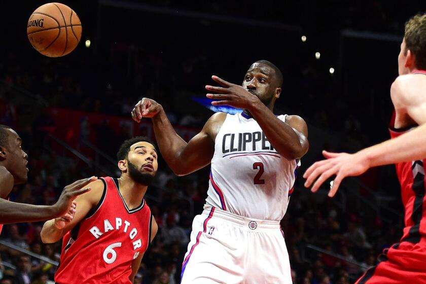 Clippers backup point guard Raymond Felton flips a pass to a teammate after driving down the lane against the Raptors in a preseason game Oct. 5.