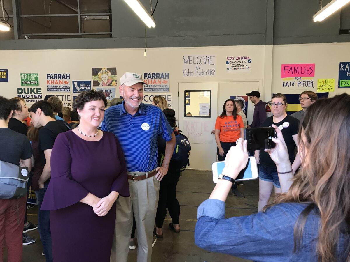 Democrat Katie Porter takes a photo with a volunteer at her campaign’s Tustin corporate office park headquarters Saturday.