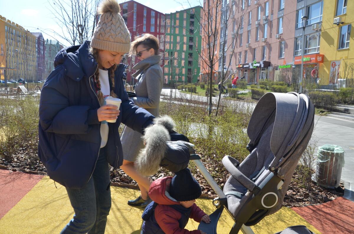 Elizaveta Pankratova pushes a stroller with her son, Kristian, at Comfort Town.