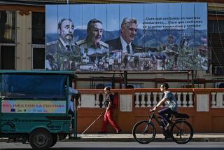 People pass near a poster of (L-R) Cuban late leader Fidel Castro, Former president Raul Castro and President Miguel Diaz Canel, in Havana, on May 20, 2026 (Photo by YAMIL LAGE / AFP via Getty Images)
