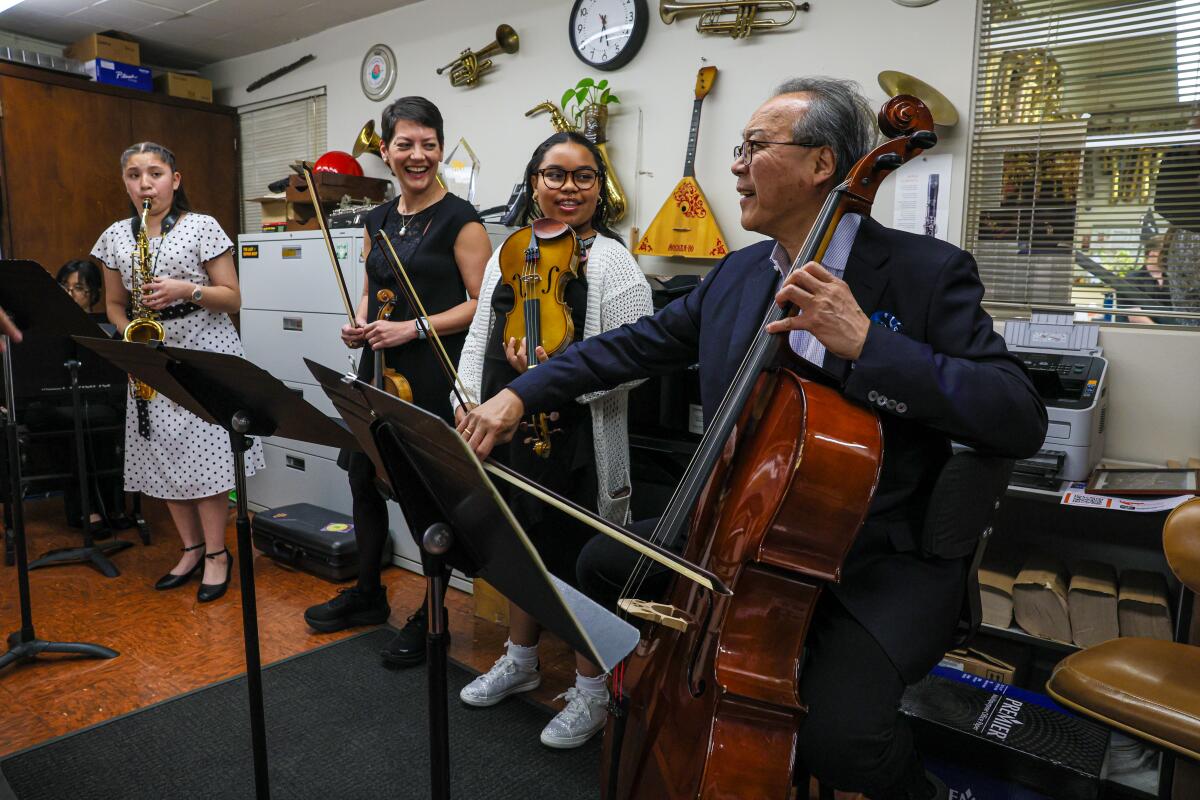 Yo-Yo Ma rehearses with current or former public-school students at a fundraiser for a program providing free instruments.