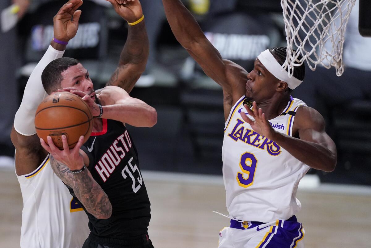Houston's Austin Rivers grabs a rebound in front of the Lakers' Rajon Rondo.