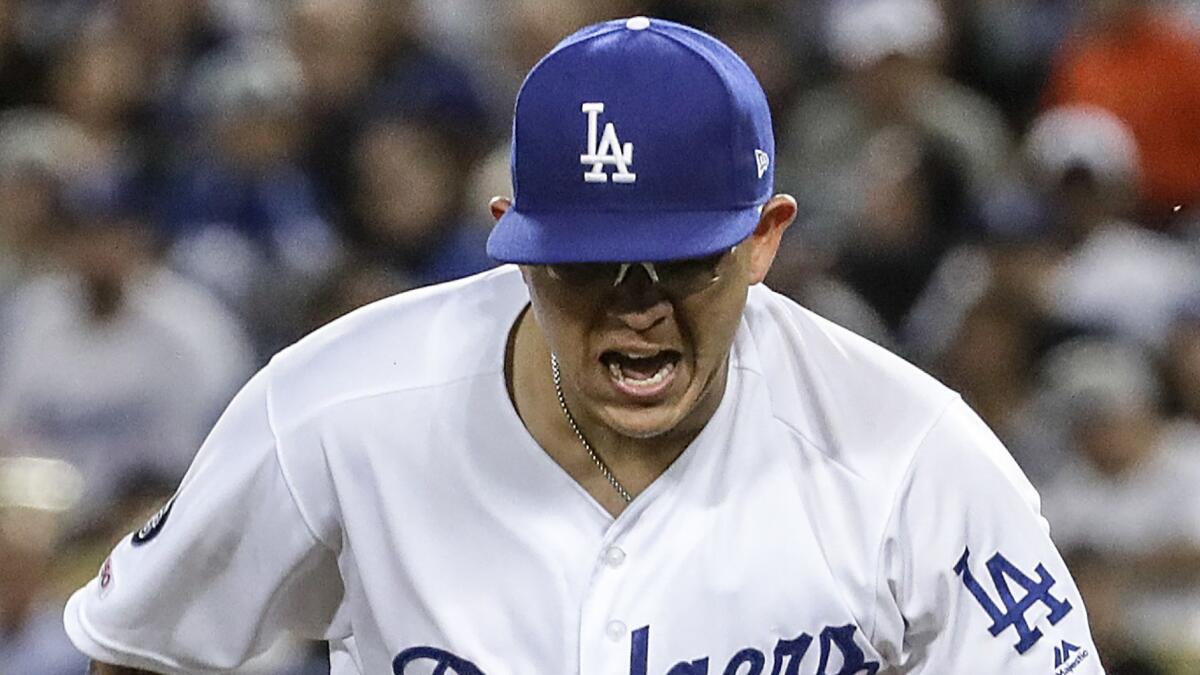 Dodgers pitcher Julio Urías exults after striking out Giants' Steve Duggar to end the fifth inning.