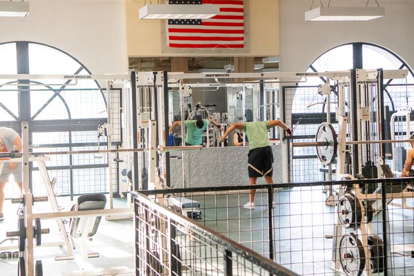 SAN FRANCISCO, CA - MARCH 03, 2021 - A man works works out at a 24 Hour Fitness gym in San Francisco, California on March 03, 2021. 24 Hour Fitness requires a reservation to work out and maxes out at 10% capacity as San Francisco moves into the red tier of the Covid-19 pandemic. (Josh Edelson/for the Times)