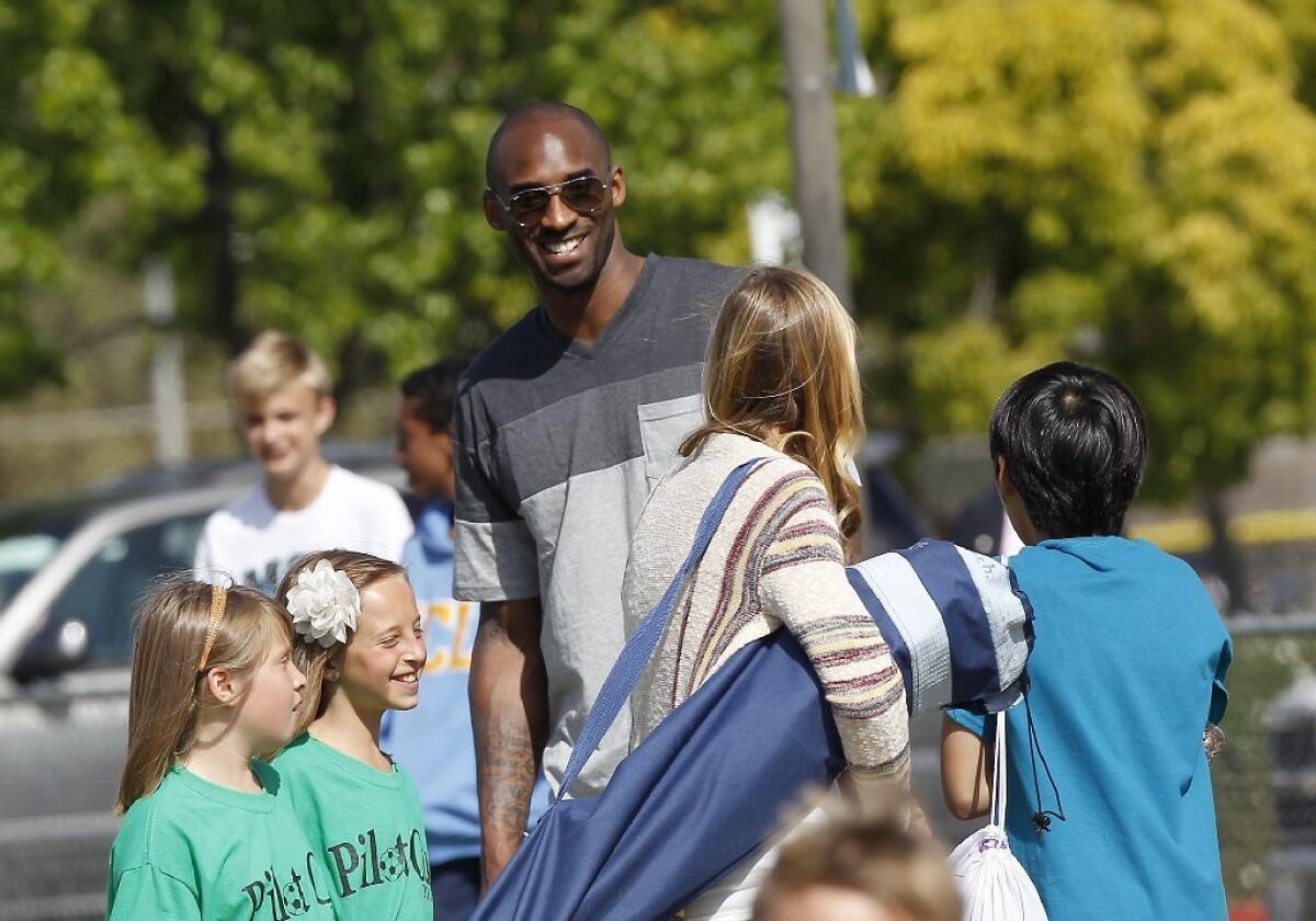 Kobe Bryant greets parents at the Daily Pilot Cup youth soccer tournament in 2013.