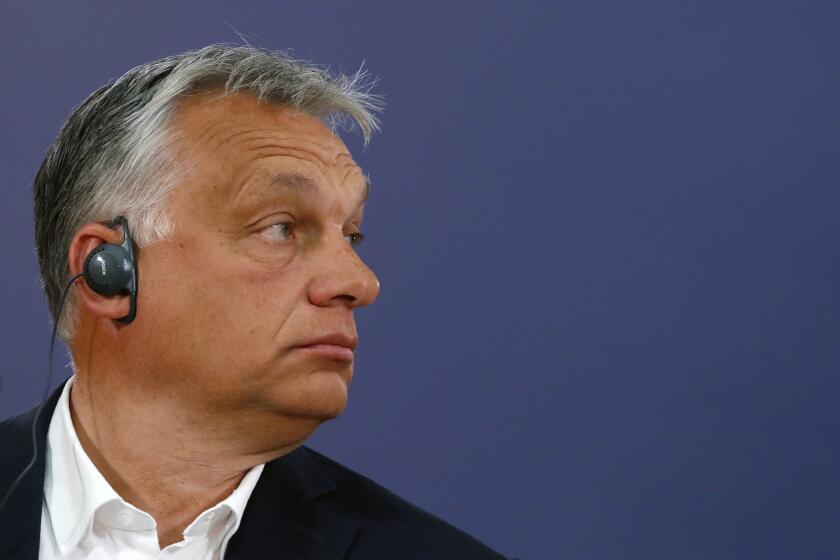 Hungarian Prime Minister Viktor Orban listens to a question during a press conference after a meeting with Serbian President Aleksandar Vucic in Belgrade, Serbia, Friday, May 15, 2020. Orban is on a one-day official visit to Serbia. (AP Photo/Darko Vojinovic)