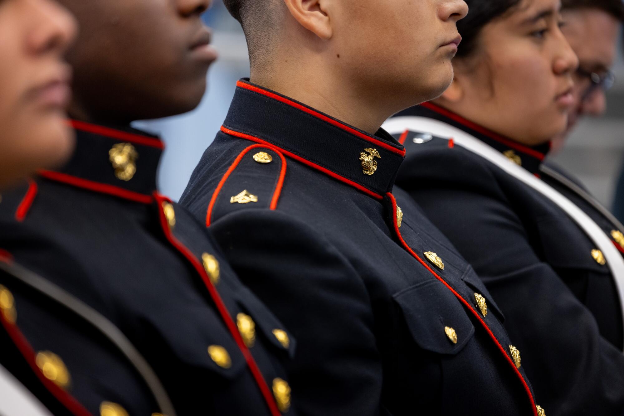 Marine Corps Junior Reserve Officer Training Corps (JROTC) Color Guard members listen to a panel of retired military veterans