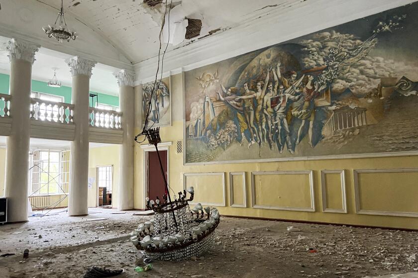 RUBIZHNE, UKRAINE- April 20, 2022: Damage from Russian shelling sits in the Rubizhne Cultural Palace, which is acting as a shelter for roughly a dozen people, in Rubizhne, Ukraine, Tuesday, April 20, 2022. (Nabih Bulos / Los Angeles Times)