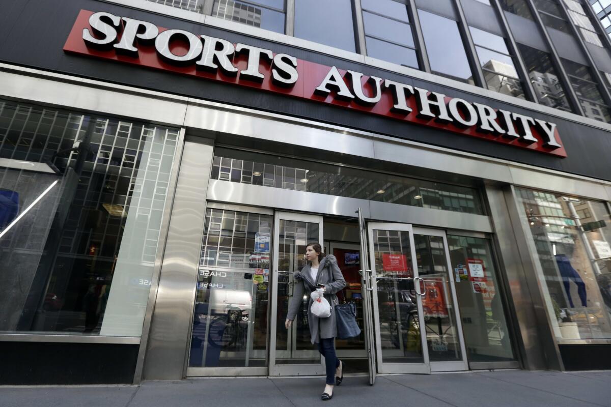 A woman leaves a Sports Authority store in New York on Wednesday, March 2, 2016. Sports Authority is filing for Chapter 11 bankruptcy protection.